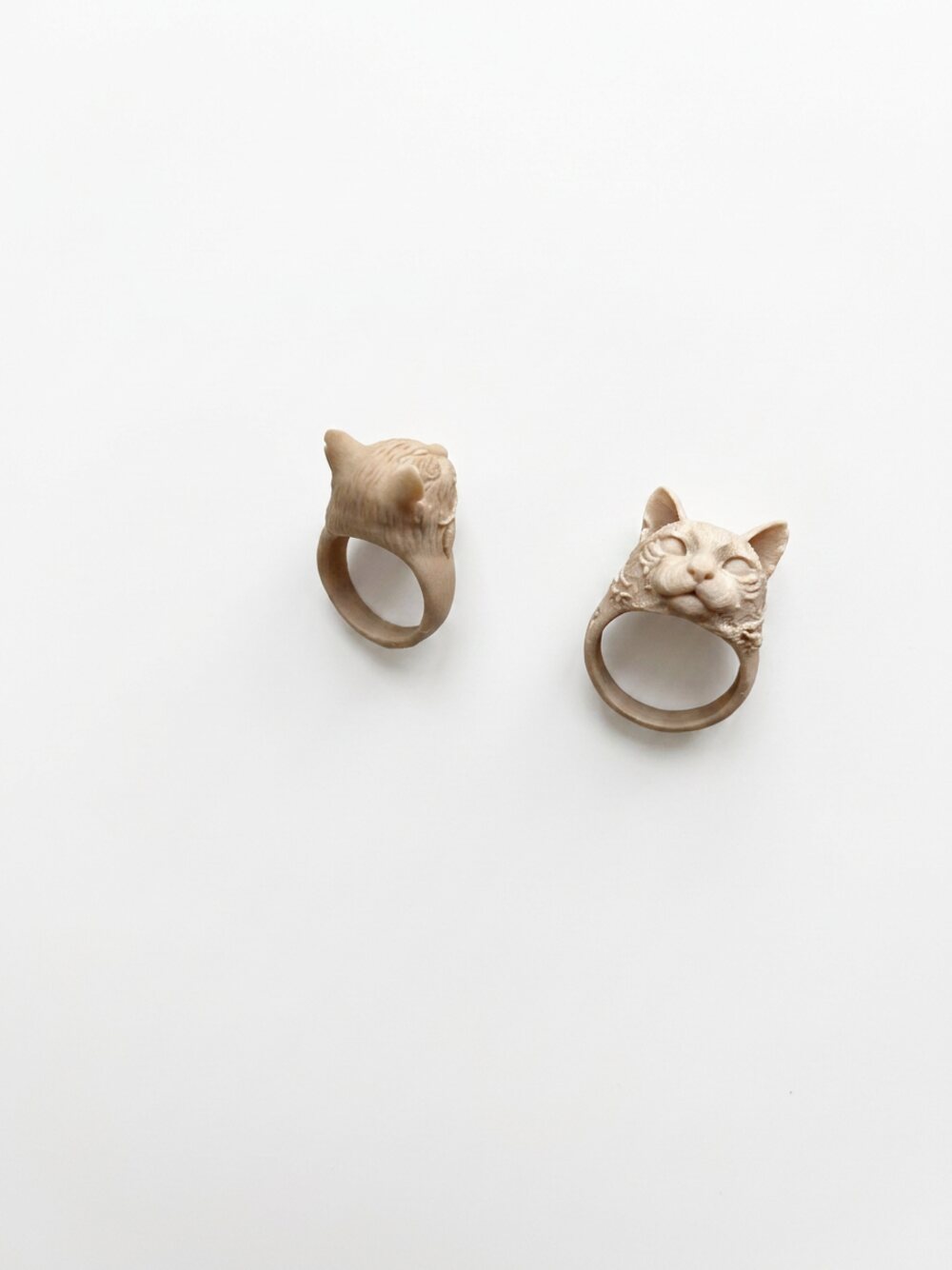Two custom cat face rings sculpted on the band